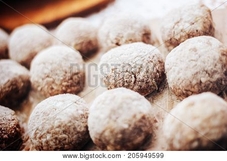 Wooden background. Uncooked turkey burgers on wooden board. Preparing dinner.