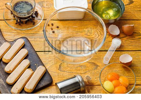 Picture of savoyardi cookies on cutting board, cups, coffee, cream cheese, yolks, squirrels