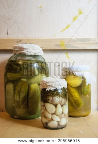 Assortie Jars Of Marinated Vegetables Picles Tomato On Wooden Background