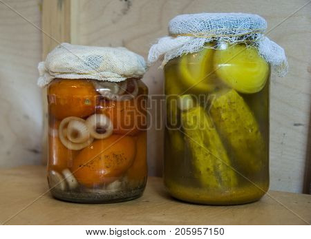 Assortie Jars Of Marinated Vegetables Picles Tomato On Wooden Background