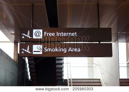 Heathrow Airport, Longford, UK: March 05, 2017: Free internet and smoking area sign pointing the direction up the stairs. Free internet is now available in most public places.