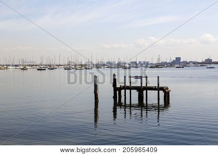 St Kilda, Victoria, Australia: April 04, 2017: St Kilda marina on a very calm blue sky day with yachts moored in the bay. This area is very popular with tourist and locals alike.