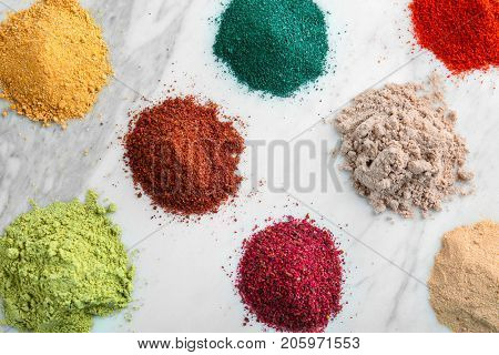 Various colorful superfood powders on light background