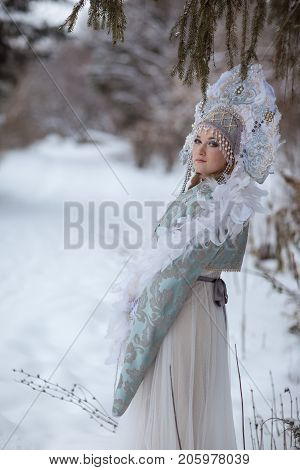 woman in a Snow Maiden costume in a winter forest