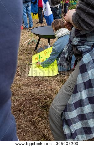 Shannon, Ireland, June. 5, 2019: A Lady Writing Out Signs Against The Donald Trump Visit With Signs 