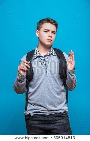 Outraged Schoolboy Teenager With A School Backpack, Expresses Negative Emotions, Feels Annoyed And F