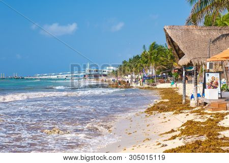 PLAYA DEL CARMEN,MEXICO - APRIL 19,2019 : The beach at Playa del Carmen on a sunny summer day