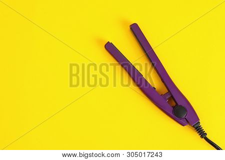 Modern Hair Iron For Straightening On Color Background, Top View With Space For Text