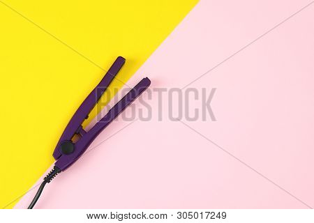 Modern Hair Iron For Straightening On Color Background, Top View With Space For Text