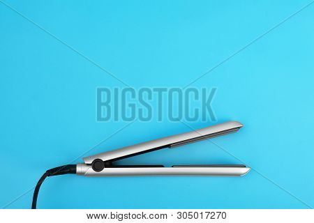 Modern Hair Iron For Straightening On Color Background, Top View With Space For Text