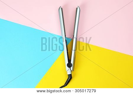 Modern Hair Iron For Straightening On Color Background, Top View