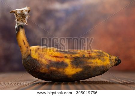 An Overripe Banana On A Wood Table