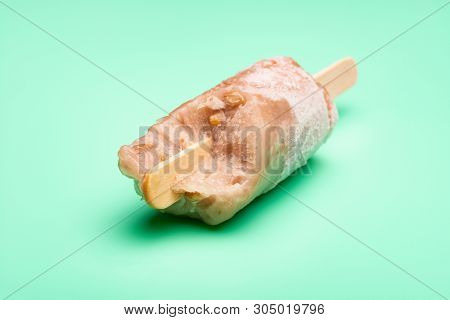 Green Bean Popsicle On A Light Green Background With Some Bites