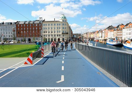 Copenhagen, Denmark: May 12, 2019 - People On Bikes Drive On Inderhavnsbroen Bridge In Copenhagen Ny