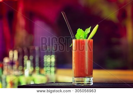 Bloody Mary At The Bar Counter. Classic Cocktail. Dark Background With Neon Lights. Horizontal, Ligh
