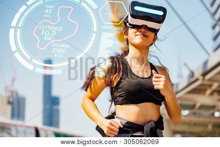 Sports Technology Concept.beauty Asian Woman Running By Virtual Reality In The City. Vr Headset Glas