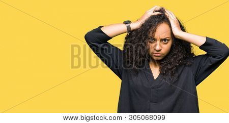 Young beautiful girl with curly hair wearing elegant dress suffering from headache desperate and stressed because pain and migraine. Hands on head.