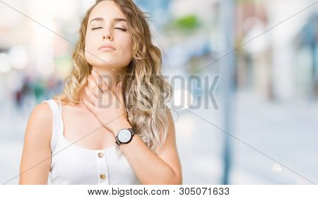 Beautiful young blonde woman over isolated background Touching painful neck, sore throat for flu, clod and infection