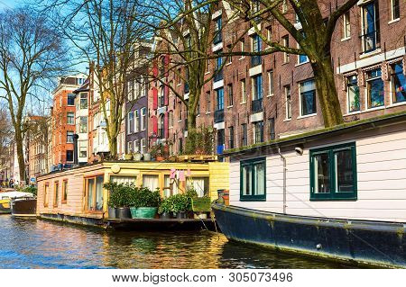 Amsterdam, Netherlands Traditional Boat House On Water And Street Houses View
