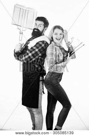 Roasting And Grilling Food. Couple In Love Hold Cooking Utensils Barbecue. Tools For Roasting Meat O