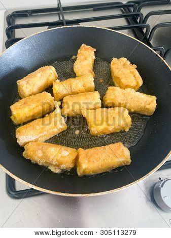 Fried Mozzarella Cheese Sticks Breaded On Frying Pan