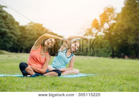 Yoga Woman On Green Grass.group Of Adults Attending A Yoga Class Outside In Park.family Or Friends E