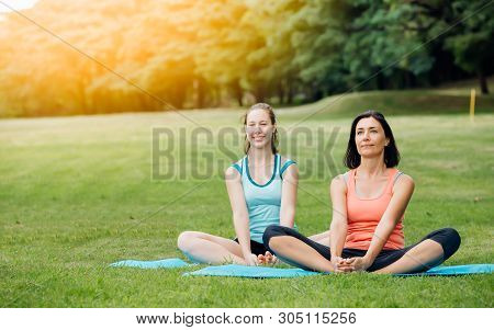 Yoga Woman On Green Grass.group Of Adults Attending A Yoga Class Outside In Park.family Or Friends E