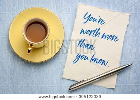You are worth more than you know - handwriting on a piece of handmade rag paper with a cup of coffee