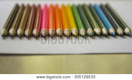 ..multicolored Pencils Lie On A White Table.