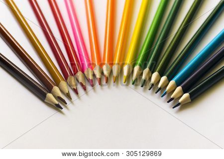 ..multicolored Pencils Lie On A White Table.