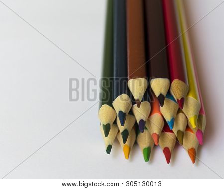 ..multicolored Pencils Lie On A White Table.