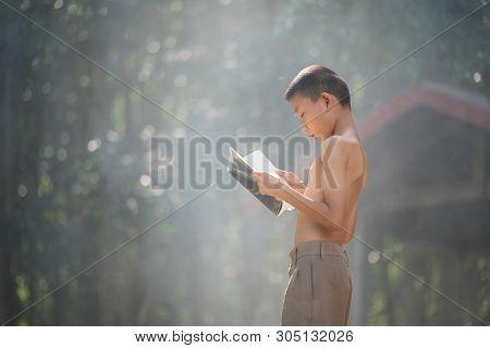 Asian Students Reading Books In Thailand Countryside, Rural Children Are Reading A Book At The Fores