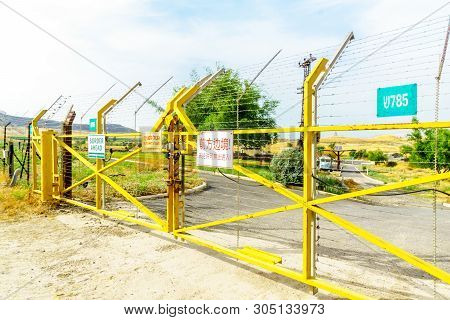 Gesher, Israel - June 04, 2019: The Jordan River Valley, And Border Gate With Warning Signs, Near Th