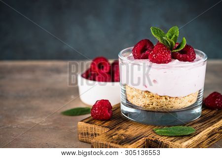 No Baked Cheesecake With Raspberry In Glass Jar. Healthy Dessert.