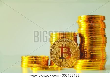 Stack Of Glod Bitcoins With A Single Coin Facing The Camera In B Sharp Focus, Cryptocurrency Concept