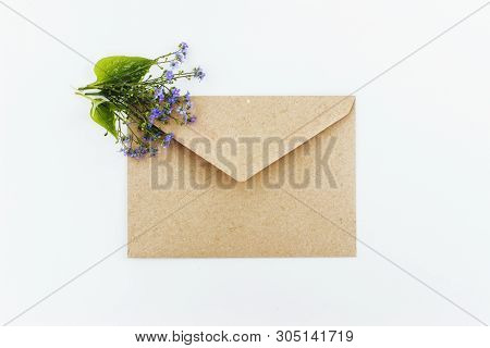 Little Cute Blue Forget-me-nots In A Kraft Paper Envelope, Selective Focus. Beautiful Bouquet Of Blu
