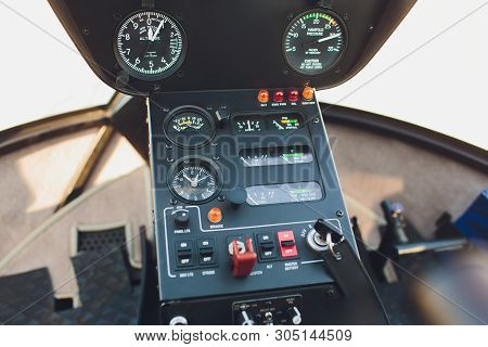 Black Control Panel In A Helicopter Cockpit.