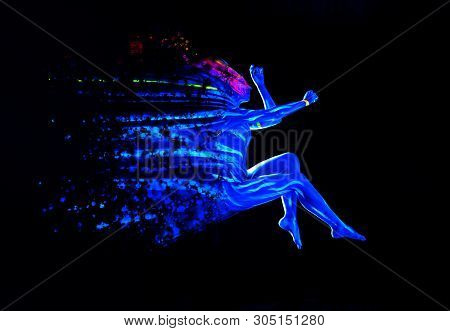 Ultraviolet Black Light Glowing Bodyart On Young Womans Body. Dispersing Girl On Black Background. A