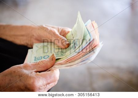 Hand The Old Man The Banknote Thai Money For Saving. Money Saving Concept, Benefits Elderly People, 
