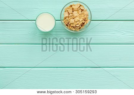 Cereals, Oatflakes And Cornflakes With Milk For Healthy Breakfast On Mint Wooden Background Top View