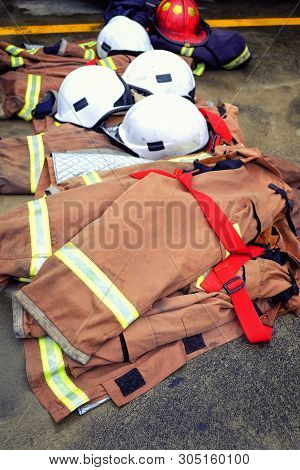 Close Up Coat Hat Fire Extinguisher On The Ground.after Trun Off On Fire