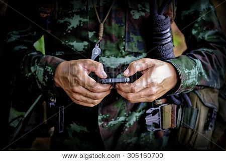 Mid Section Of Military Soldier Using Mobile Phone In Boot Camp War. Historical Re-enactment With A 