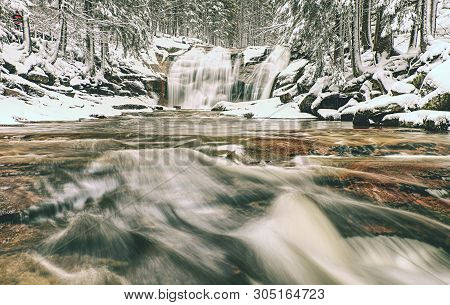 Light Dusting Of Snow Creating A Winter Scene At The Mumlavsky Waterfall At Mumlava River.