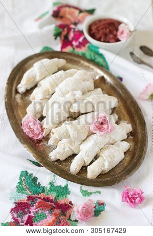 Traditional Romanian Or Moldavian Shortcake Cookies With Jam Stuffing And A Cup Of Tea On The Light 