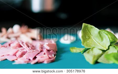 Chopped Up Ingredients For Pizza Toppings Are Laid Out On A Bright Blue Chopping Board - Includes Ba