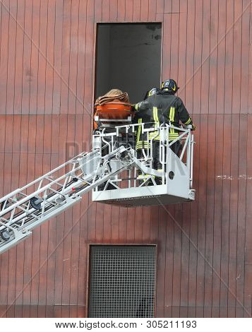 Rescue Of An Injured Person With Stretcher On The Aerial Platform During A Fire Drill