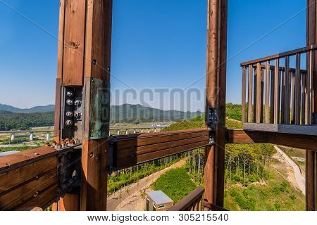Wooden Beams Of Tower On Mountain Top At Public Park With View Of Landscape And Structures Below In 