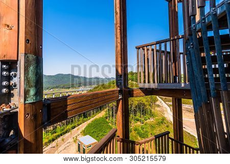 Wooden Beams Of Tower On Mountain Top At Public Park With View Of Landscape And Structures Below In 