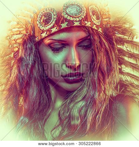 Colorful, beautiful girl with plume of american indian feathers