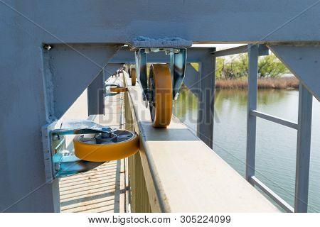 Close-up Detail Of Strong Roller Wheel Guides On Metal Structure - Outside Picture Of Sliding Metal 